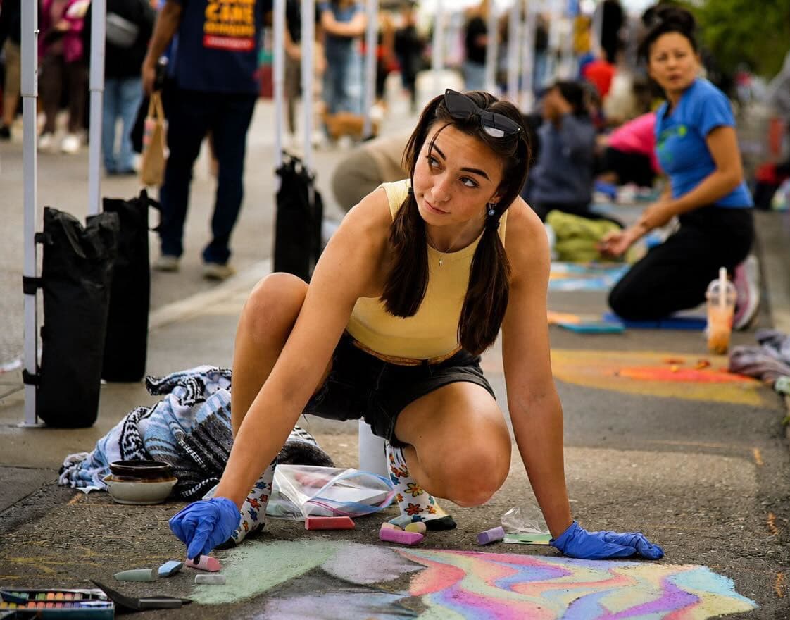 Vanessa Maillet drawing in chalk at a street festival